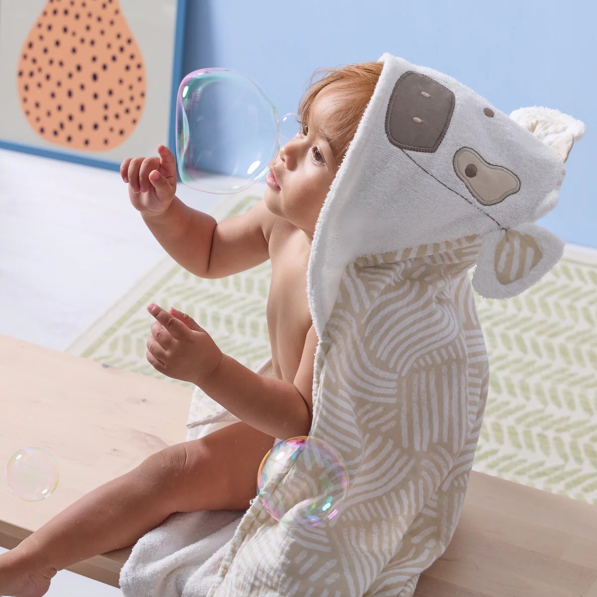 clemi-the-cow-hooded-towel-toddler-blows-bubbles